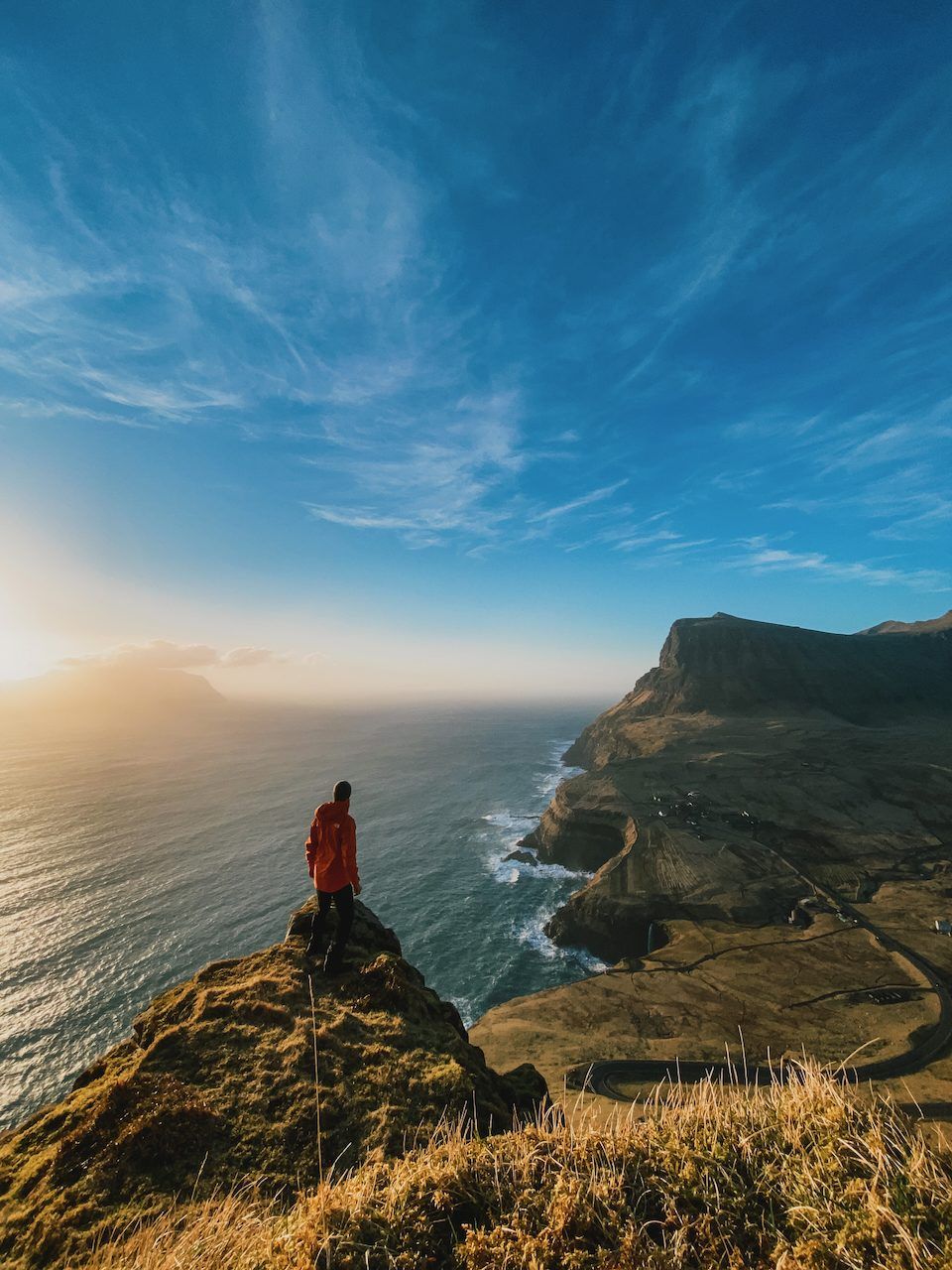 Polle on a cliff edge above the sea at sunset